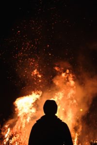 Person standing in front of a bonfire